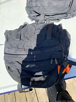 Front view showing MEC logo, mesh pocket, straps, orange pull tab