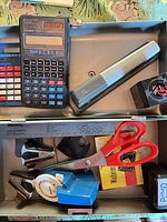 Top view showing calculators, stapler and part of box