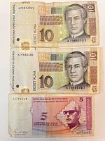 Fronts of three banknotes showing denominations, portraits and serial numbers