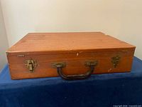 Closed wooden case showing handle and latches