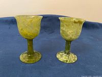 Front view of both jade goblets on blue background