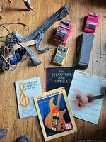 Group view of pedals, cables, straps, books spread on floor