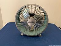 Front view of Sunbeam desk fan showing grille and blades