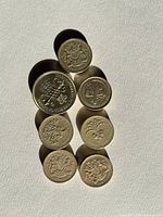 Seven UK £1 coins showing varied reverse designs