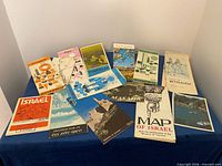 Overview of all fold-out maps and brochures spread on table