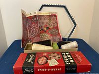 Loom, booklet, box lid, open box with thread spools displayed