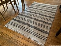 Full view of rug on floor showing pattern and dimensions