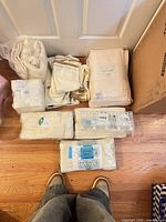 Assorted packaged towel sets on floor showing colors and packaging