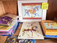 Shelf with Carousel Animals coloring book, sympathy card box, carousel horse art print, drawstring bags, mesh pouches visible