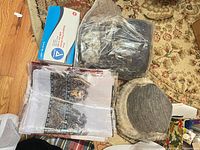 Box of masks, bandana pack, fedora in plastic, faux-fur earflap hat