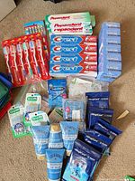 Full lot overview showing toothpaste, toothbrushes, soap boxes, foot cream, sanitizing wipes and dental picks