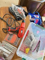 Overall lot showing rotary tool, jigsaw, bit sets and storage bin