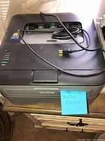 Top view of Brother laser printer with coiled cable