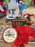 Group shot of all items: bows, clock, plush, garland, light sets