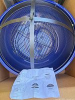 blue metal mesh fire pit with grate and manual