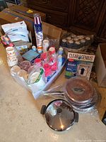 Group shot of pans, saucepan, water filter box, and disposable tableware