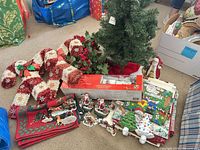 Group view of tree, candy canes, boxed GE figure, figurines, linens