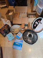 Group shot of all items: turntable, jars, fry pan, mugs, ice packs, lid, bowl