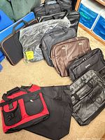 Group of six laptop bags in various colours and materials