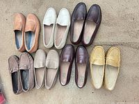 All seven pairs of loafers arranged side by side showing colors, materials and general wear