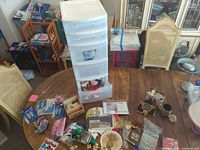 Overall lot on table with storage tower and assorted items spread out