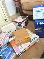 Group shot showing ION scanner, LaserJet toner, TN660 pack, PS2 scale, Philips DVD, Maxell media