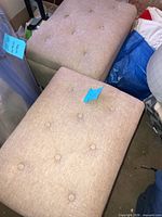 Top view of both ottomans showing tufted lids and overall colour