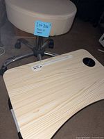 Rolling chair seat and base with lap desk in foreground