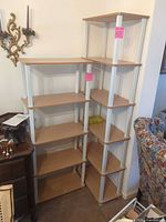 Front view of both laminate bookshelves showing tiers and white supports