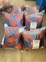 Six plaid pillows sealed in plastic