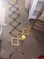 three accordion peg racks on floor showing size and finishes
