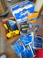 Lot overview showing toilet paper pack, vacuum bag packs and flashlights