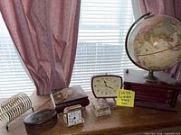overall lot on desk showing globe, clocks, boxes, napkin holder