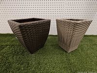 Front view of both tapered square faux wicker planters on turf