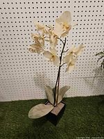 Full view of artificial orchid plant showing height, leaves, and planter