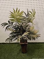 Full view of artificial palm plant showing height and pot