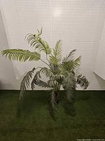 Full view of artificial palm plant against wall