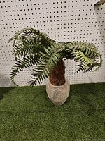 Full view of artificial palm plant in pot