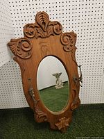 Full view carved oak mirror with brass sconces