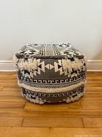 Front view of square ottoman showing pattern and fringe