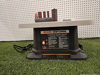 Front view of sander showing label, base and power cord