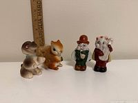 Front view of four ceramic pieces with ruler for scale