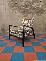 three-quarter view of the chair showing frame and upholstery pattern