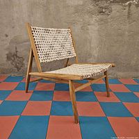 Front angle of wood frame chair with woven cord seat/back