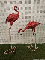 Both metal flamingo sculptures full view