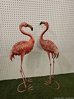 Both flamingo sculptures full view