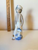 Front view of figurine with ruler for scale