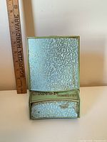 Closed case front view with ruler for scale