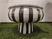 side view showing striped design and pedestal base