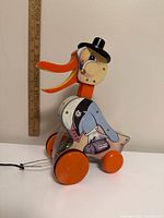 Left side view of Dr. Doodle Duck showing graphics, wheels, pull cord, measuring stick for scale